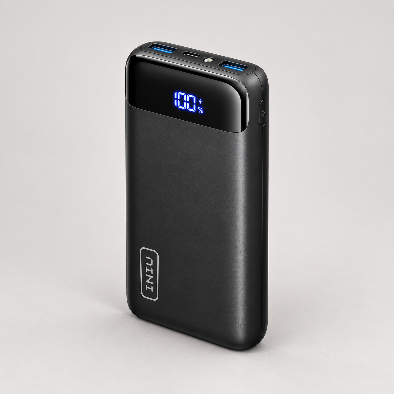 Editorial illustration of an INIU black power bank core body; electrical revision, ratings and port direction are not established.