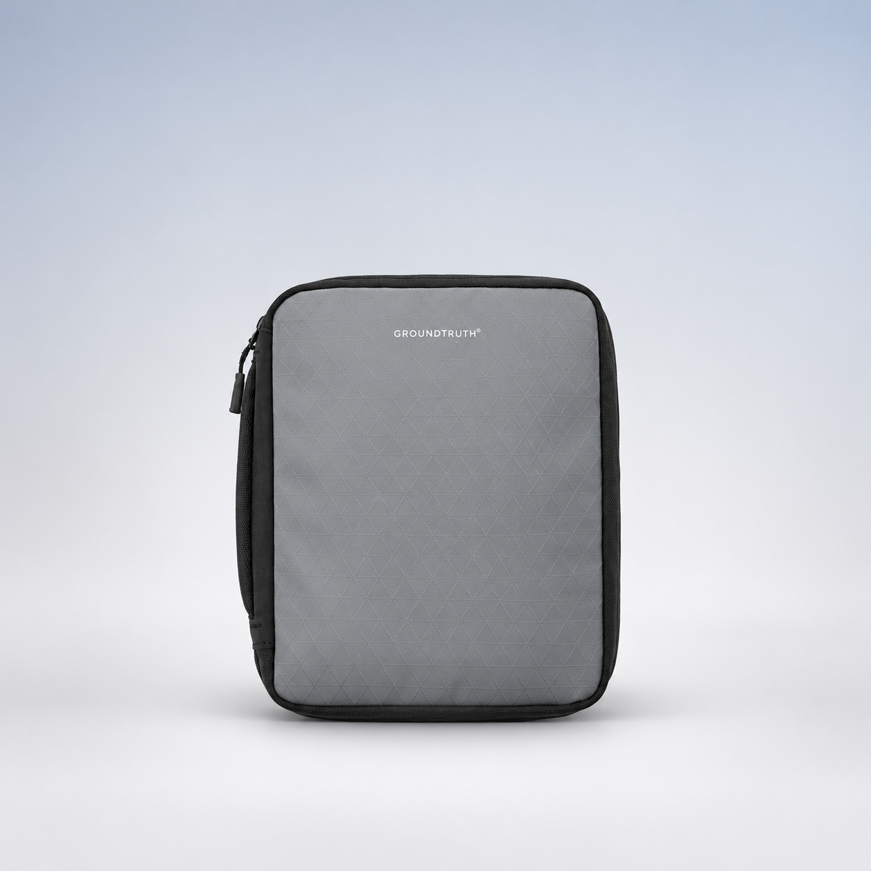 Editorial illustration of GROUNDTRUTH RIKR Tech Pouch, Summit Grey; visible model recognition only, not a technical or complete-pack diagram.