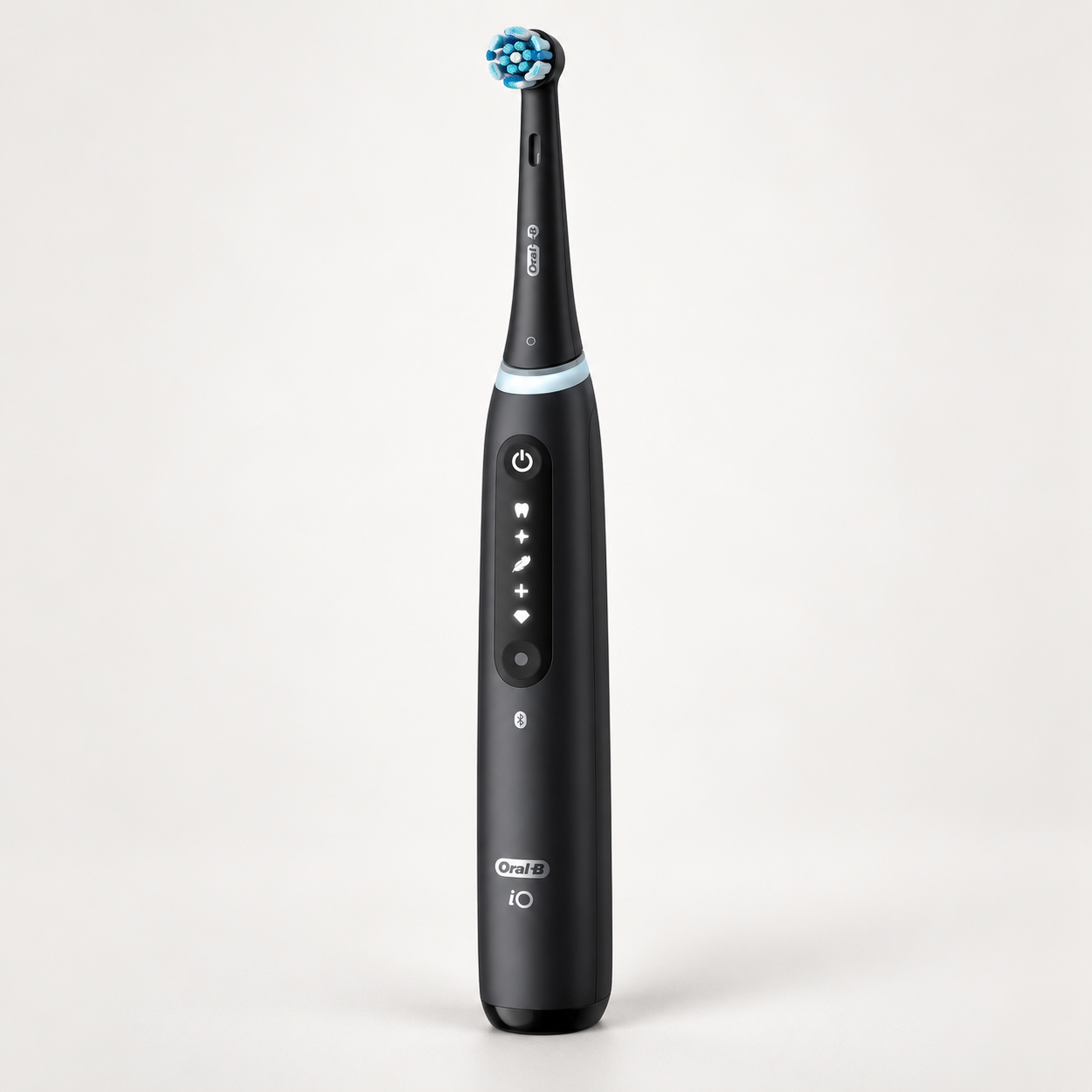Editorial illustration of the Oral-B iO5 Matt Black handle with round brush head; accessories not shown.