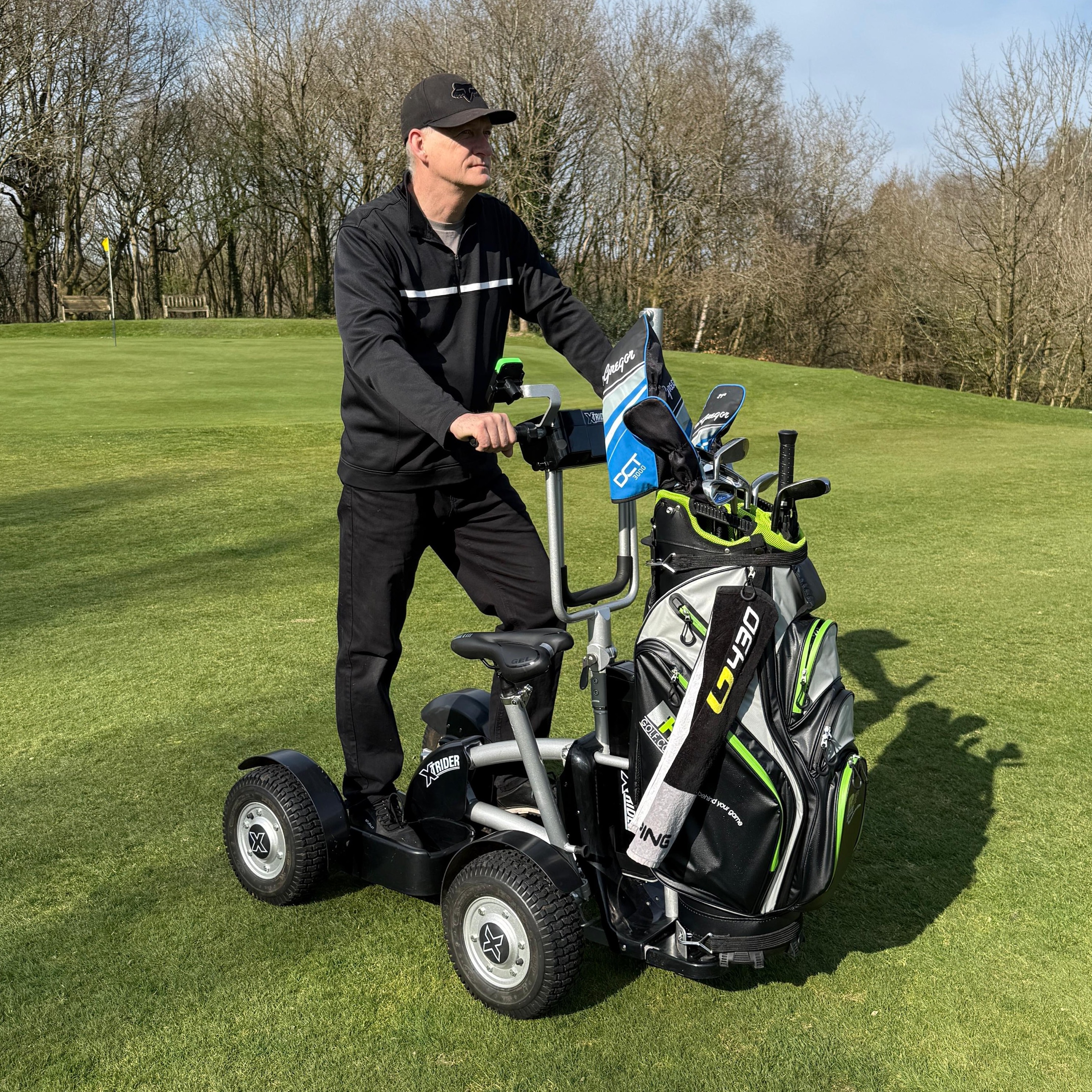 Xtrider XTR001 with standing rider, illustrative golf bag and optional saddle fitted; accessories not assumed included.